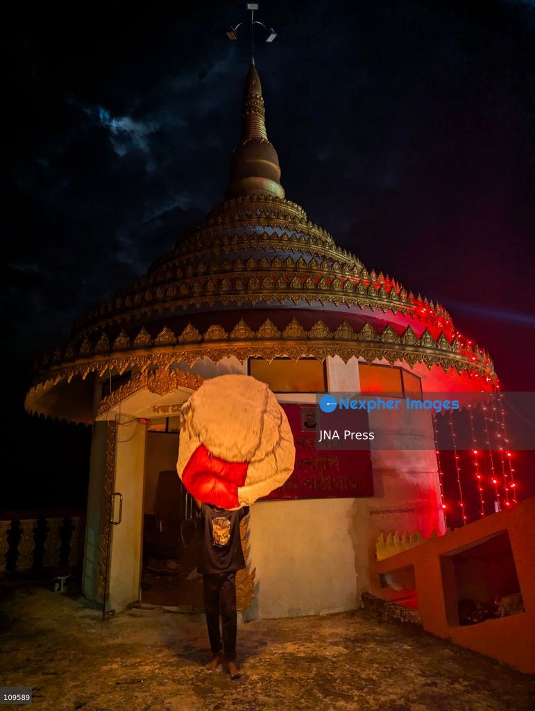 CHITTAGONG, BANGLADESH - OCTOBER 25, 2026: Devotees gather at a Buddhist temple during Prabarana Purnima celebrations, as colourful lights illuminate the temple grounds and illuminated lanterns rise into the night sky. The festival marks an important occasion in the Buddhist calendar, bringing communities together through religious traditions and cultural celebrations. (Photo by Sumon Das/JNA Press via Nexpher Images)