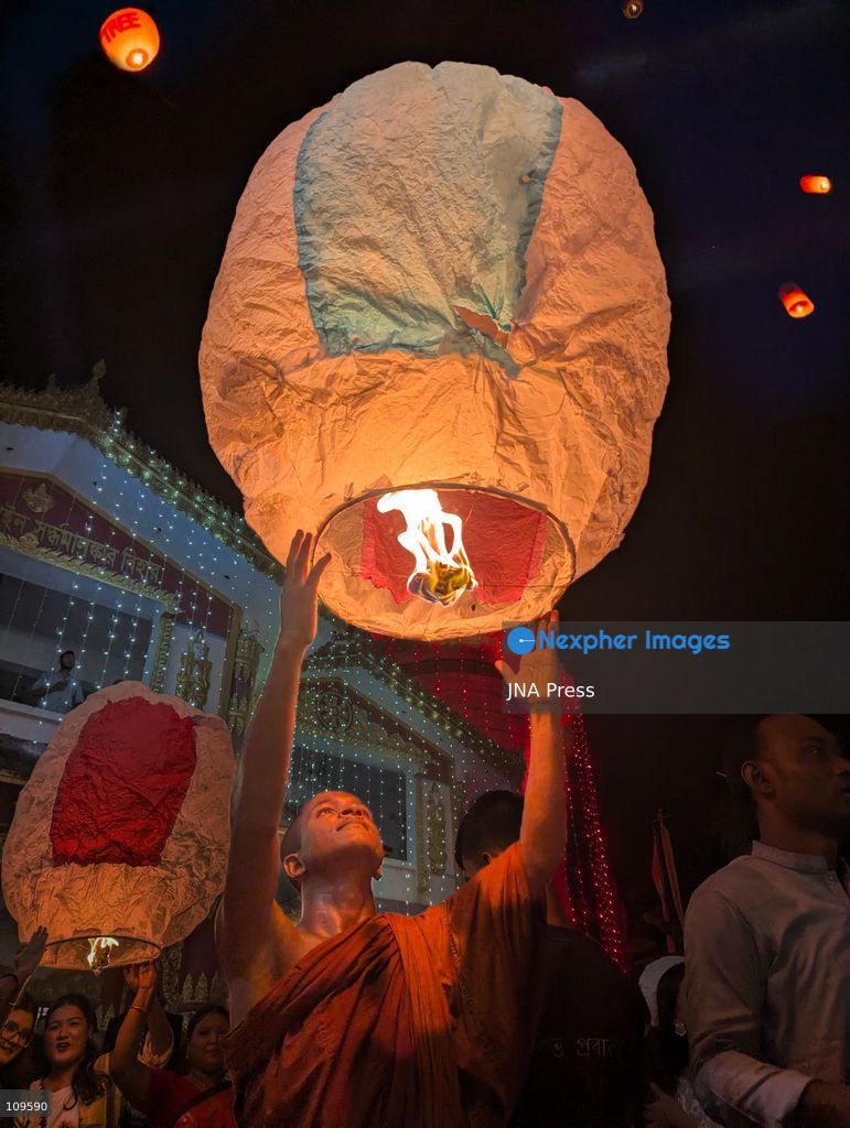 CHITTAGONG, BANGLADESH - OCTOBER 25, 2026: Devotees gather at a Buddhist temple during Prabarana Purnima celebrations, as colourful lights illuminate the temple grounds and illuminated lanterns rise into the night sky. The festival marks an important occasion in the Buddhist calendar, bringing communities together through religious traditions and cultural celebrations. (Photo by Sumon Das/JNA Press via Nexpher Images)