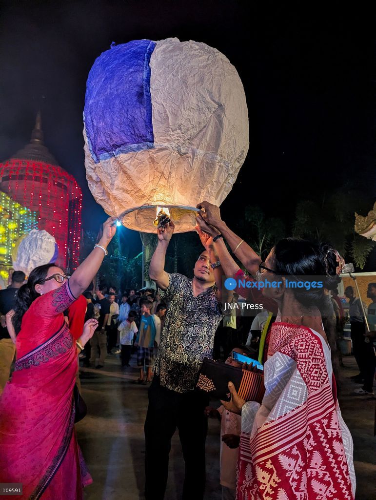 CHITTAGONG, BANGLADESH - OCTOBER 25, 2026: Devotees gather at a Buddhist temple during Prabarana Purnima celebrations, as colourful lights illuminate the temple grounds and illuminated lanterns rise into the night sky. The festival marks an important occasion in the Buddhist calendar, bringing communities together through religious traditions and cultural celebrations. (Photo by Sumon Das/JNA Press via Nexpher Images)