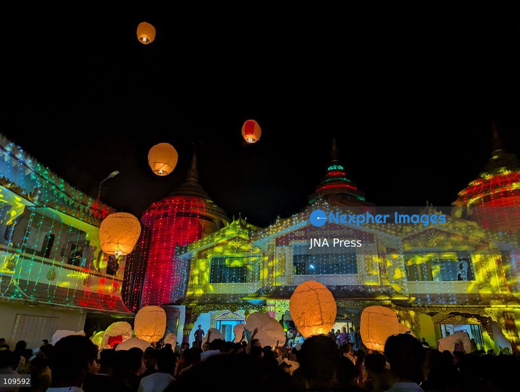 CHITTAGONG, BANGLADESH - OCTOBER 25, 2026: Devotees gather at a Buddhist temple during Prabarana Purnima celebrations, as colourful lights illuminate the temple grounds and illuminated lanterns rise into the night sky. The festival marks an important occasion in the Buddhist calendar, bringing communities together through religious traditions and cultural celebrations. (Photo by Sumon Das/JNA Press via Nexpher Images)