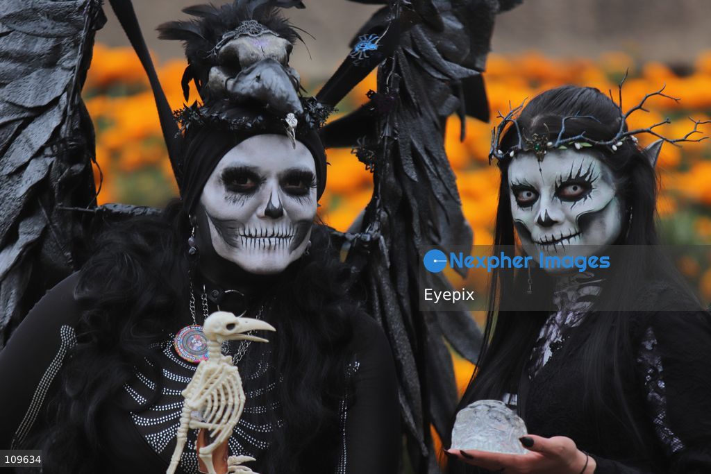 A couple with their faces painted with skull makeup take part in the 13th annual Mega Procession of Catrinas along Paseo de la Reforma avenue. Thousands of persons gathered for the massive parade, a key cultural prelude to the upcoming Day of the Dead (Día de Muertos) celebrations, showcasing elaborate makeup, vibrant costumes, and honoring Mexican skull iconography. on October 25, 2026 in Mexico City, Mexico. (Photo by Carlos Santiago/ Eyepix Group/Eyepix via Nexpher Images)