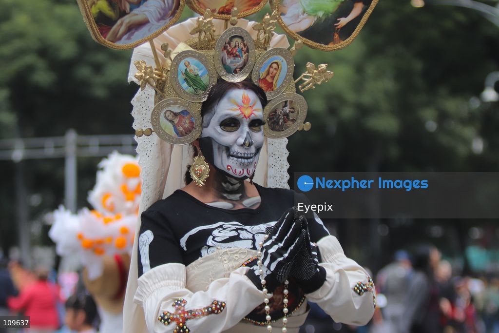 A participant dressed and painted as a traditional 'Catrina' takes part during the 13th annual Mega Procession of Catrinas along Paseo de la Reforma avenue. Thousands of persons gathered for the massive parade, a key cultural prelude to the upcoming Day of the Dead (Día de Muertos) celebrations, showcasing elaborate makeup, vibrant costumes, and honoring Mexican skull iconography. on October 25, 2026 in Mexico City, Mexico. (Photo by Carlos Santiago/ Eyepix Group/Eyepix via Nexpher Images)
