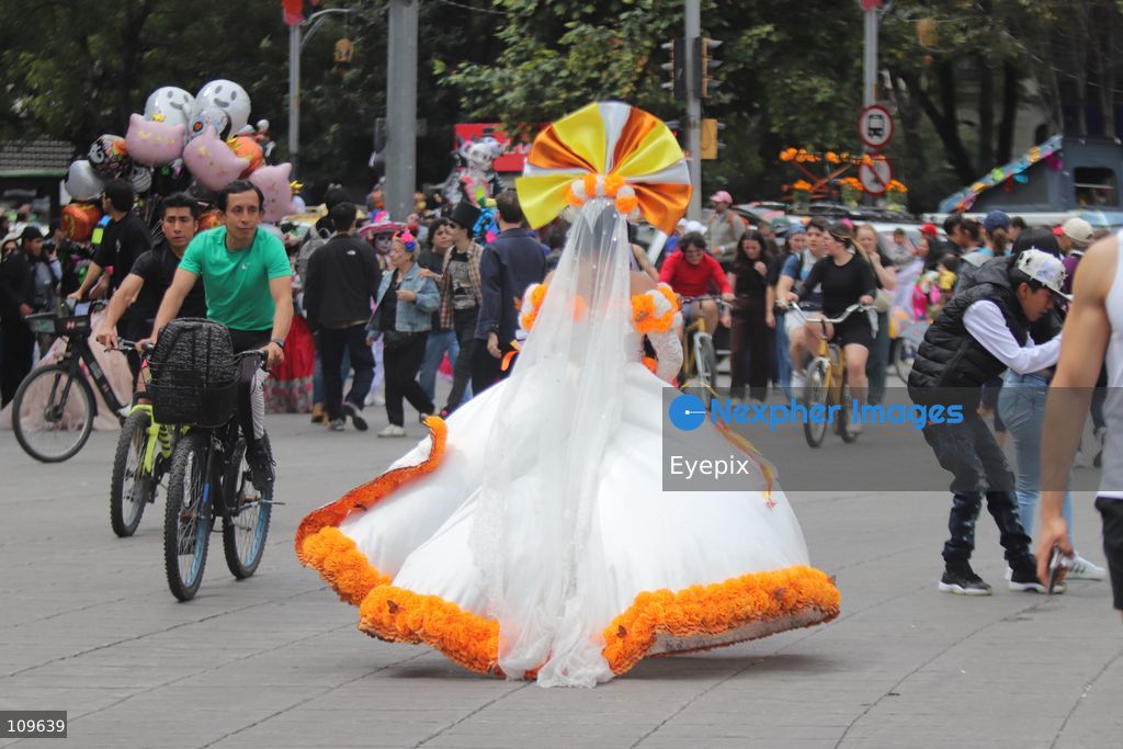 A participant dressed and painted as a traditional 'Catrina' takes part during the 13th annual Mega Procession of Catrinas along Paseo de la Reforma avenue. Thousands of persons gathered for the massive parade, a key cultural prelude to the upcoming Day of the Dead (Día de Muertos) celebrations, showcasing elaborate makeup, vibrant costumes, and honoring Mexican skull iconography. on October 25, 2026 in Mexico City, Mexico. (Photo by Carlos Santiago/ Eyepix Group/Eyepix via Nexpher Images)