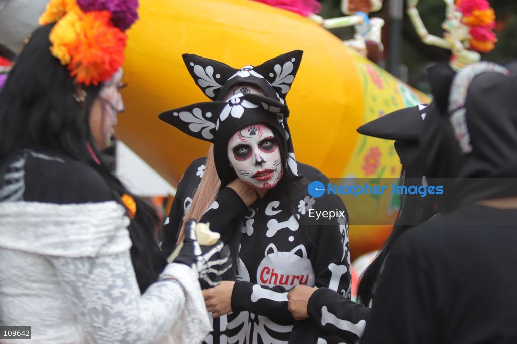 A participant with her face painted with skull makeup takes part during the 13th annual Mega Procession of Catrinas along Paseo de la Reforma avenue. Thousands of persons gathered for the massive parade, a key cultural prelude to the upcoming Day of the Dead (Día de Muertos) celebrations, showcasing elaborate makeup, vibrant costumes, and honoring Mexican skull iconography. on October 25, 2026 in Mexico City, Mexico. (Photo by Carlos Santiago/ Eyepix Group/Eyepix via Nexpher Images)