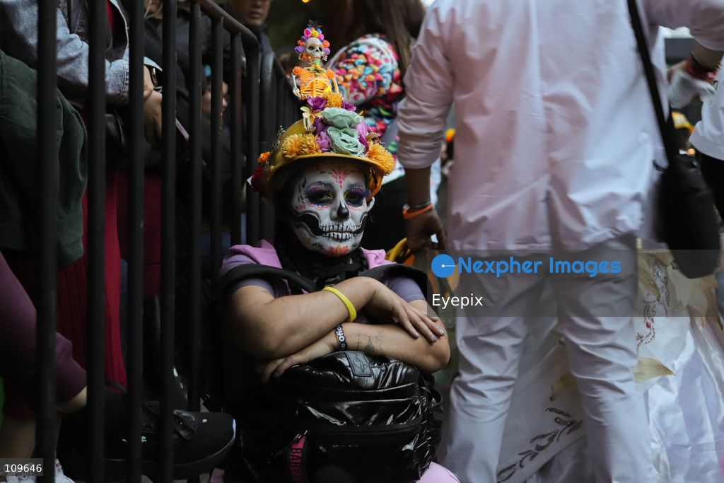 A woman with her face painted with Catrina makeup takes part during the 13th annual Mega Procession of Catrinas along Paseo de la Reforma avenue. Thousands of persons gathered for the massive parade, a key cultural prelude to the upcoming Day of the Dead (Día de Muertos) celebrations, showcasing elaborate makeup, vibrant costumes, and honoring Mexican skull iconography. on October 25, 2026 in Mexico City, Mexico. (Photo by Carlos Santiago/ Eyepix Group/Eyepix via Nexpher Images)