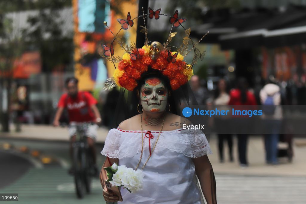 A woman with her face painted with Catrina makeup takes part during the 13th annual Mega Procession of Catrinas along Paseo de la Reforma avenue. Thousands of persons gathered for the massive parade, a key cultural prelude to the upcoming Day of the Dead (Día de Muertos) celebrations, showcasing elaborate makeup, vibrant costumes, and honoring Mexican skull iconography. on October 25, 2026 in Mexico City, Mexico. (Photo by Carlos Santiago/ Eyepix Group/Eyepix via Nexpher Images)