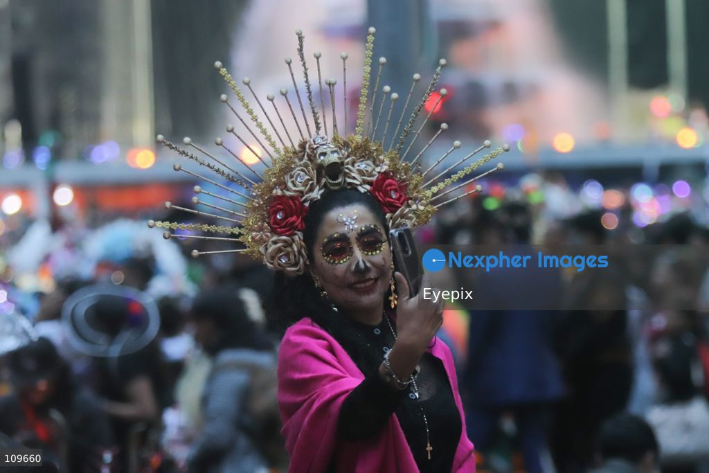 A participant dressed and painted as a traditional 'Catrina' takes part during the 13th annual Mega Procession of Catrinas along Paseo de la Reforma avenue. Thousands of persons gathered for the massive parade, a key cultural prelude to the upcoming Day of the Dead (Día de Muertos) celebrations, showcasing elaborate makeup, vibrant costumes, and honoring Mexican skull iconography. on October 25, 2026 in Mexico City, Mexico. (Photo by Carlos Santiago/ Eyepix Group/Eyepix via Nexpher Images)