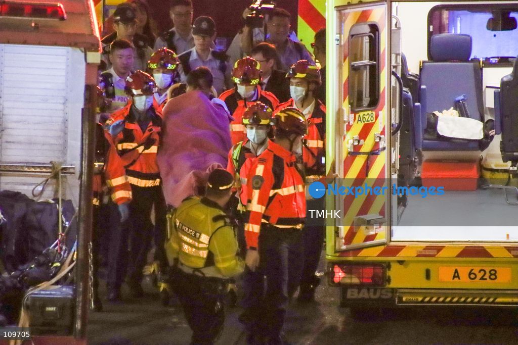 Firefighters, police officers and paramedics attend the scene of a suspended working platform accident outside Jardine House in Central, Hong Kong, on October 26, 2026. Two workers were left stranded on the building's exterior at the 35th and 43rd floors before being rescued by firefighters. (Photo by Gordon Choi/TMHK via Nexpher Images)