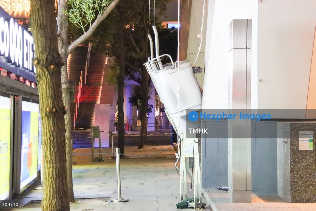 A suspended working platform hangs near ground level outside Jardine House in Central, Hong Kong, on October 26, 2026, after it suddenly plunged, leaving two workers stranded high on the building's exterior. Both workers were subsequently rescued by firefighters. (Photo by Gordon Choi/TMHK via Nexpher Images)