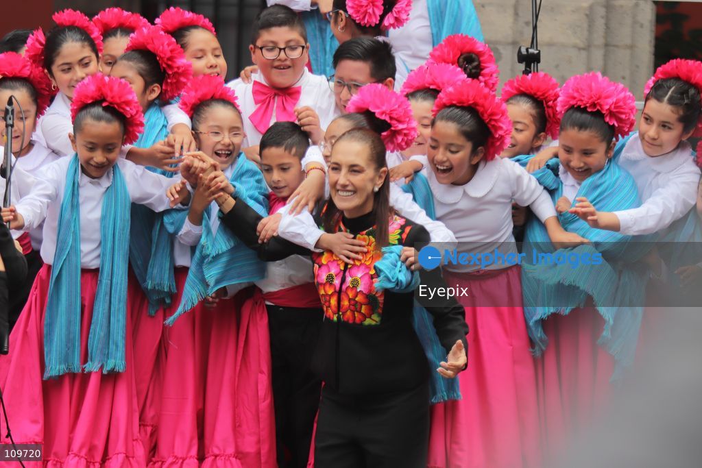 Mexico’s President Claudia Sheinbaum Pardo greets children from a school choir, dressed in traditional regional costumes during the presentation of the first National School Choir Contest (Primer Concurso Nacional de Coros Escolares) inside the Main Patio at the National Palace on October 26, 2026 in Mexico City, Mexico. (Photo by Carlos Santiago/ Eyepix Group/Eyepix via Nexpher Images)