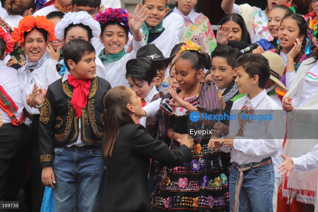 Mexico’s President Claudia Sheinbaum Pardo greets children from a school choir, dressed in traditional regional costumes during the presentation of the first National School Choir Contest (Primer Concurso Nacional de Coros Escolares) inside the Main Patio at the National Palace on October 26, 2026 in Mexico City, Mexico. (Photo by Carlos Santiago/ Eyepix Group/Eyepix via Nexpher Images)