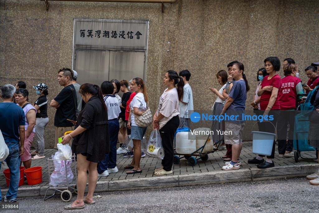 Residents lining up at a water truck after a water main burst in Shau Kei Wan on October 27, 2026 in Hong Kong. (Photo by Vernon Yuen/Nexpher Images)