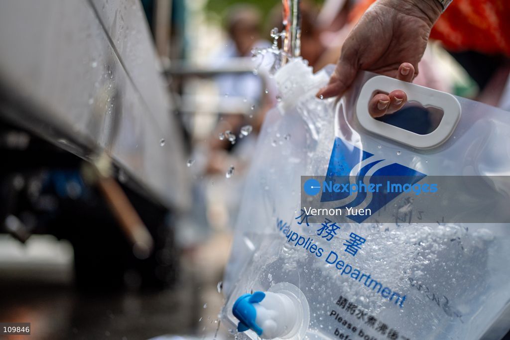 Residents filling up plastic water containers at a water truck after a water main burst in Shau Kei Wan on October 27, 2026 in Hong Kong. (Photo by Vernon Yuen/Nexpher Images)
