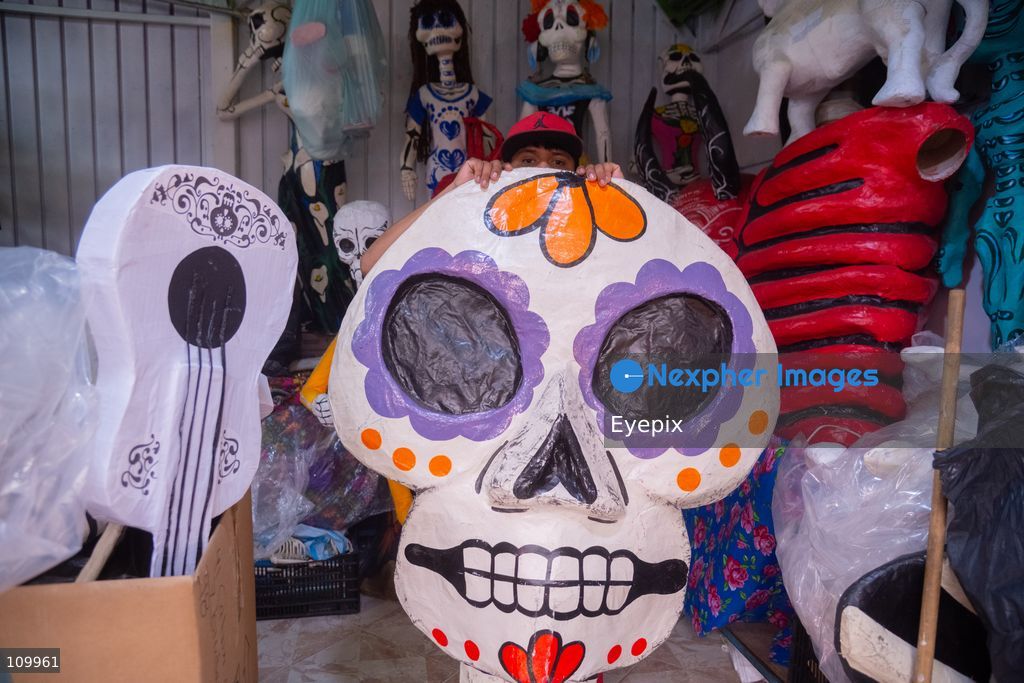 Handcrafted papier-mâché skulls, are displayed for sale to customers preparing for the upcoming Day of the Dead (Dia de Muertos) celebrations at the Jamaica Market on October 26, 2026 in Mexico City, Mexico. The traditional market experiences a massive influx of shoppers sourcing flowers, incense, sugar skulls, and altar decorations to honor their deceased loved ones ahead of the annual holiday celebrated on November 1 and 2. (Photo by Marko Gonzalez/ Eyepix Group/Eyepix via Nexpher Images)
