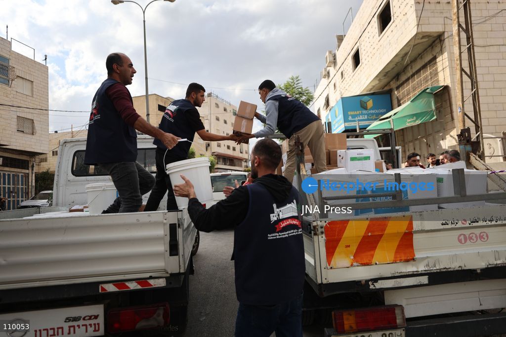 HEBRON, PALESTINE, OCTOBER 28, 2026: Relief workers collect and distribute food, medical supplies, clothing and bedding for Palestinian families displaced from the Deir Baha and Al-Jilda areas of Hebron in the occupied West Bank. The relief effort supports residents forced from their homes during an Israeli military operation that began on October 23. (Photo by Mosab shawer/JNA Press via Nexpher Images)