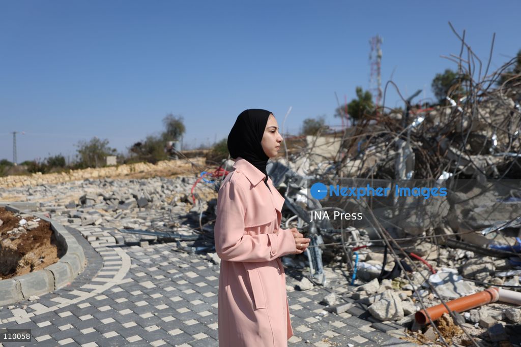 HEBRON, PALESTINE, OCTOBER 28, 2026: Dr. Mayar Marish, 23, stands with her husband, Ahmad Marish, outside the rubble of her family’s home in the Farsh al-Hawa area of Hebron in the occupied West Bank. Israeli forces demolished the home on October 23, displacing her family. Mayar had planned to hold her wedding celebration at the house in ten days. (Photo by Mosab shawer/JNA Press via Nexpher Images)
