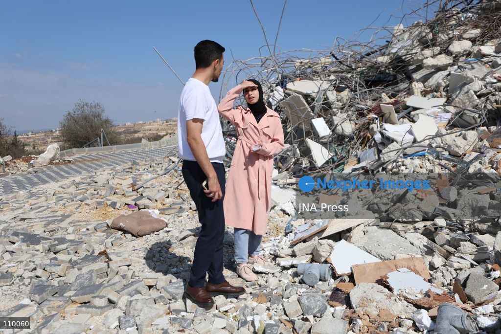 HEBRON, PALESTINE, OCTOBER 28, 2026: Dr. Mayar Marish, 23, stands with her husband, Ahmad Marish, outside the rubble of her family’s home in the Farsh al-Hawa area of Hebron in the occupied West Bank. Israeli forces demolished the home on October 23, displacing her family. Mayar had planned to hold her wedding celebration at the house in ten days. (Photo by Mosab shawer/JNA Press via Nexpher Images)