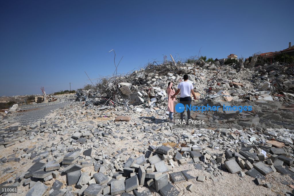 HEBRON, PALESTINE, OCTOBER 28, 2026: Dr. Mayar Marish, 23, stands with her husband, Ahmad Marish, outside the rubble of her family’s home in the Farsh al-Hawa area of Hebron in the occupied West Bank. Israeli forces demolished the home on October 23, displacing her family. Mayar had planned to hold her wedding celebration at the house in ten days. (Photo by Mosab shawer/JNA Press via Nexpher Images)