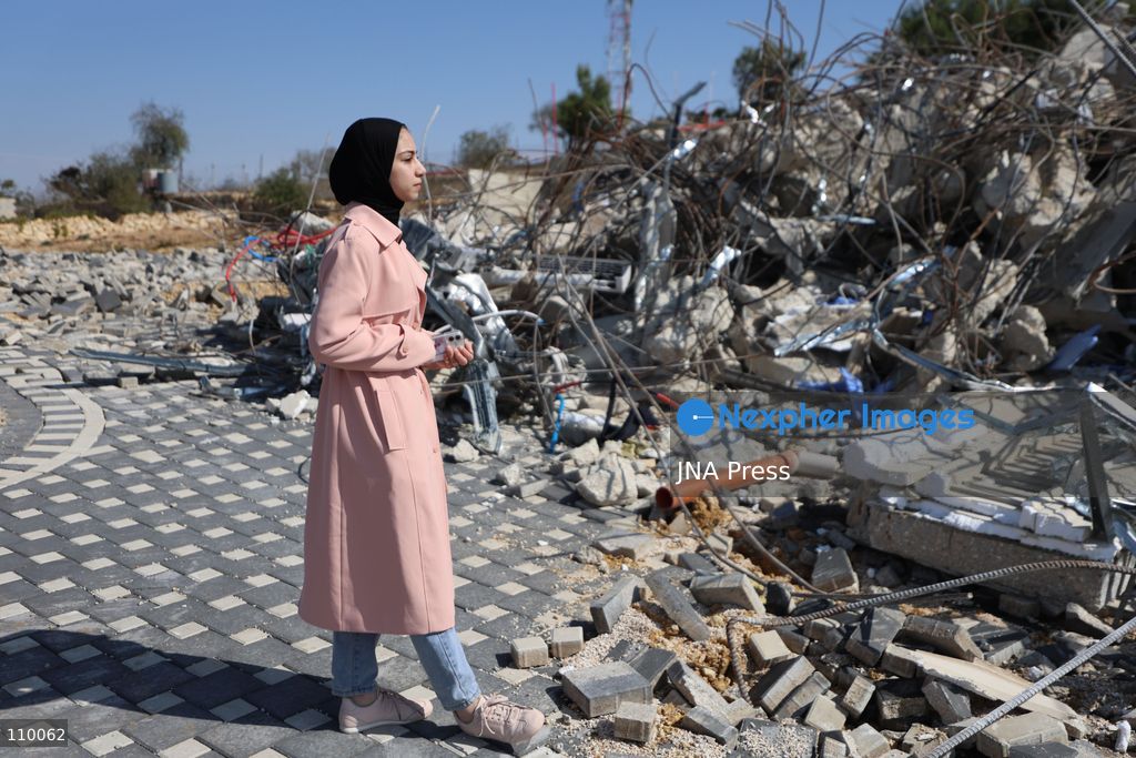 HEBRON, PALESTINE, OCTOBER 28, 2026: Dr. Mayar Marish, 23, stands with her husband, Ahmad Marish, outside the rubble of her family’s home in the Farsh al-Hawa area of Hebron in the occupied West Bank. Israeli forces demolished the home on October 23, displacing her family. Mayar had planned to hold her wedding celebration at the house in ten days. (Photo by Mosab shawer/JNA Press via Nexpher Images)