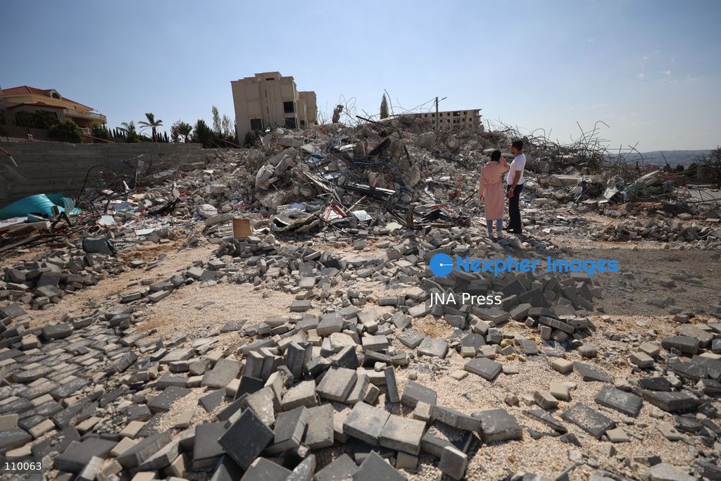 HEBRON, PALESTINE, OCTOBER 28, 2026: Dr. Mayar Marish, 23, stands with her husband, Ahmad Marish, outside the rubble of her family’s home in the Farsh al-Hawa area of Hebron in the occupied West Bank. Israeli forces demolished the home on October 23, displacing her family. Mayar had planned to hold her wedding celebration at the house in ten days. (Photo by Mosab shawer/JNA Press via Nexpher Images)