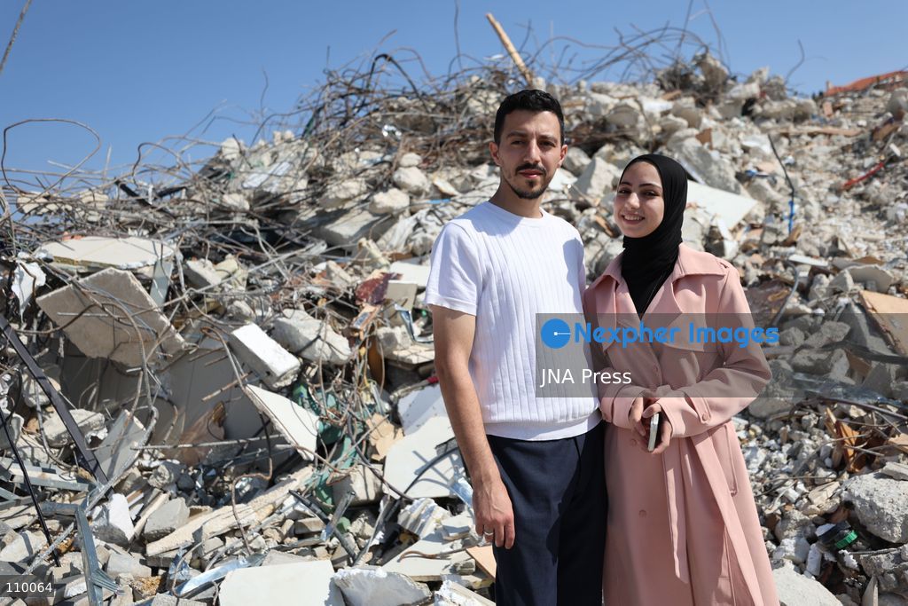 HEBRON, PALESTINE, OCTOBER 28, 2026: Dr. Mayar Marish, 23, stands with her husband, Ahmad Marish, outside the rubble of her family’s home in the Farsh al-Hawa area of Hebron in the occupied West Bank. Israeli forces demolished the home on October 23, displacing her family. Mayar had planned to hold her wedding celebration at the house in ten days. (Photo by Mosab shawer/JNA Press via Nexpher Images)