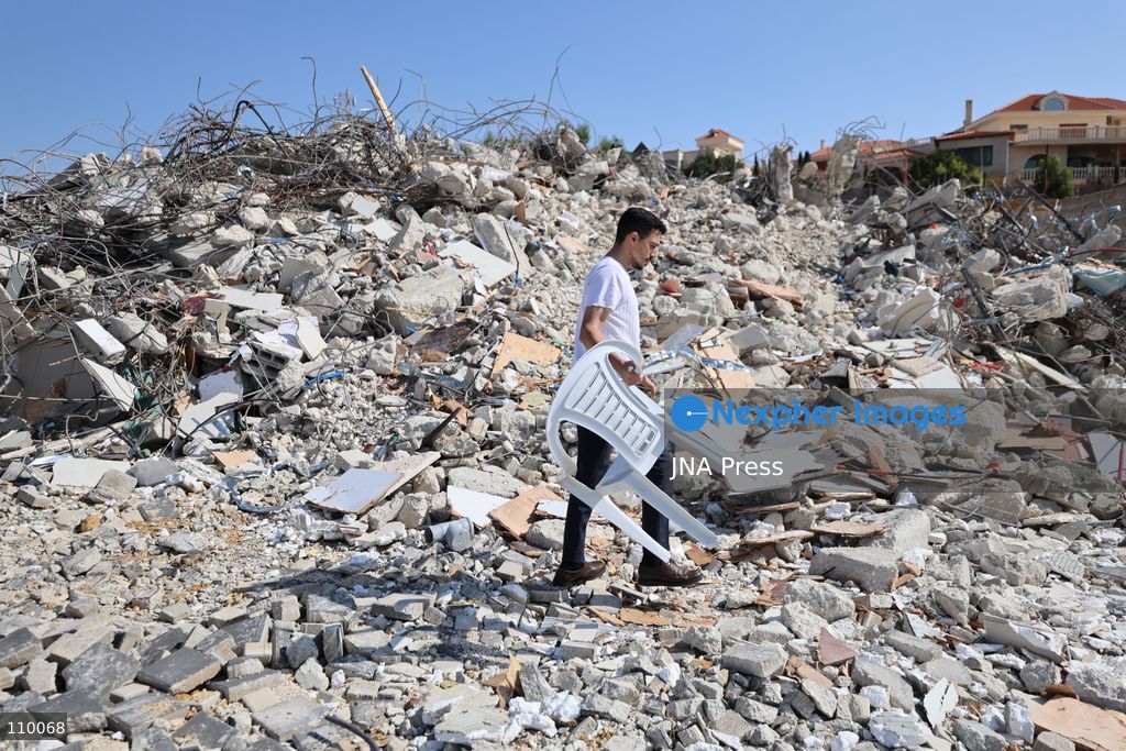 HEBRON, PALESTINE, OCTOBER 28, 2026: Dr. Mayar Marish, 23, stands with her husband, Ahmad Marish, outside the rubble of her family’s home in the Farsh al-Hawa area of Hebron in the occupied West Bank. Israeli forces demolished the home on October 23, displacing her family. Mayar had planned to hold her wedding celebration at the house in ten days. (Photo by Mosab shawer/JNA Press via Nexpher Images)