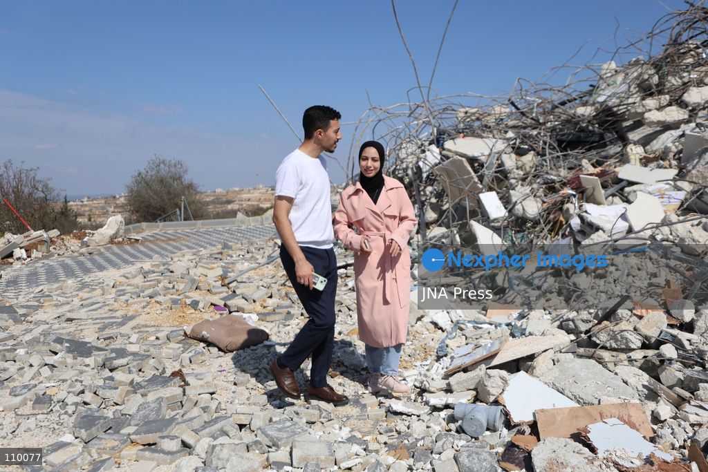 HEBRON, PALESTINE, OCTOBER 28, 2026: Dr. Mayar Marish, 23, stands with her husband, Ahmad Marish, outside the rubble of her family’s home in the Farsh al-Hawa area of Hebron in the occupied West Bank. Israeli forces demolished the home on October 23, displacing her family. Mayar had planned to hold her wedding celebration at the house in ten days. (Photo by Mosab shawer/JNA Press via Nexpher Images)