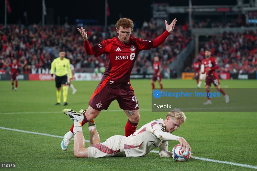 Josh Sargent #09 of Toronto FC and Matti Peltola #04 of D.C. United battle for the ball during the Major League Soccer Match between Toronto FC and DC United at BMO Field Stadium. on October 28, 2026 in Toronto, Canada. (Photo by Leonardo Ramirez / Eyepix Group/Eyepix via Nexpher Images)
