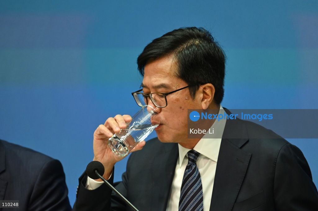 Michael Wong, Deputy Financial Secretary drinking water during Hong Kong Chief Executive John Lee, and relevant officials hold a press conference to the report of the Independent Committee in relation to the fire at Wang Fuk Court in Tai Po on October 29, 2026 in Hong Kong. (Photo by Kobe Li/Nexpher Images)
