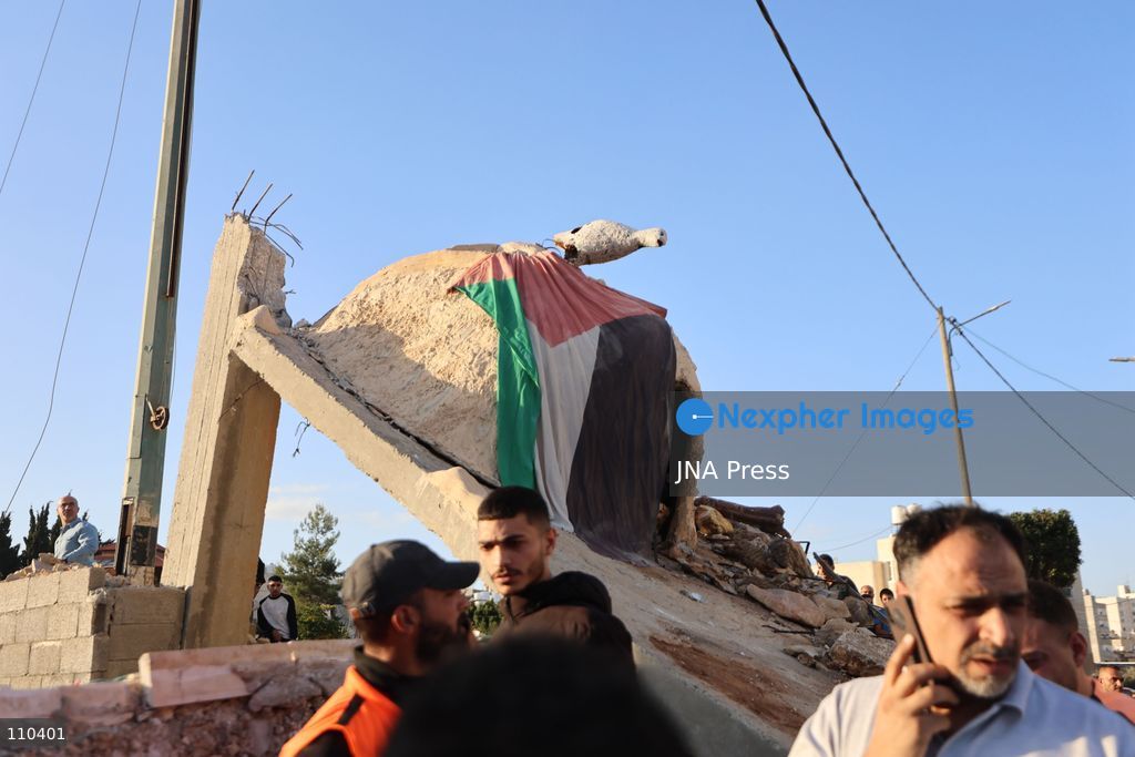 DURA, PALESTINE, OCTOBER 29, 2026: Israeli forces use a military bulldozer to demolish a memorial mural depicting Bajis Abu Atwan in the town of Dura, southwest of Hebron in the occupied West Bank. The demolition takes place during an Israeli military raid on the town. (Photo by Mosab shawer/JNA Press via Nexpher Images)