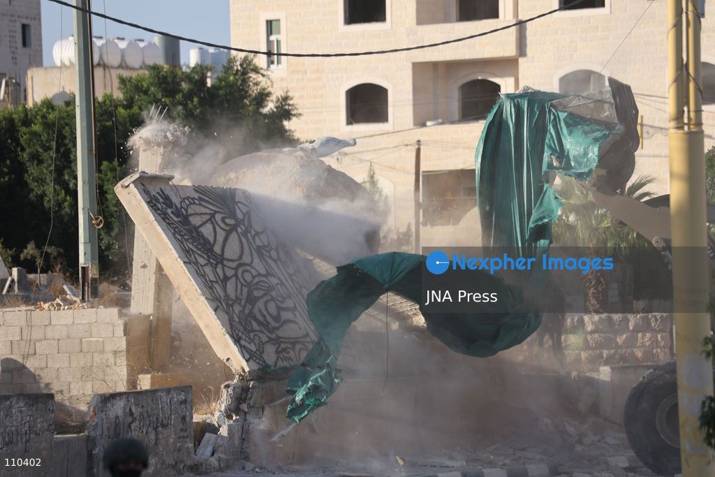 DURA, PALESTINE, OCTOBER 29, 2026: Israeli forces use a military bulldozer to demolish a memorial mural depicting Bajis Abu Atwan in the town of Dura, southwest of Hebron in the occupied West Bank. The demolition takes place during an Israeli military raid on the town. (Photo by Mosab shawer/JNA Press via Nexpher Images)