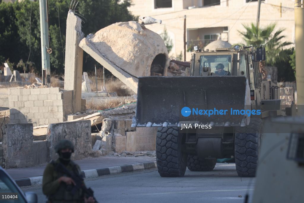 DURA, PALESTINE, OCTOBER 29, 2026: Israeli forces use a military bulldozer to demolish a memorial mural depicting Bajis Abu Atwan in the town of Dura, southwest of Hebron in the occupied West Bank. The demolition takes place during an Israeli military raid on the town. (Photo by Mosab shawer/JNA Press via Nexpher Images)