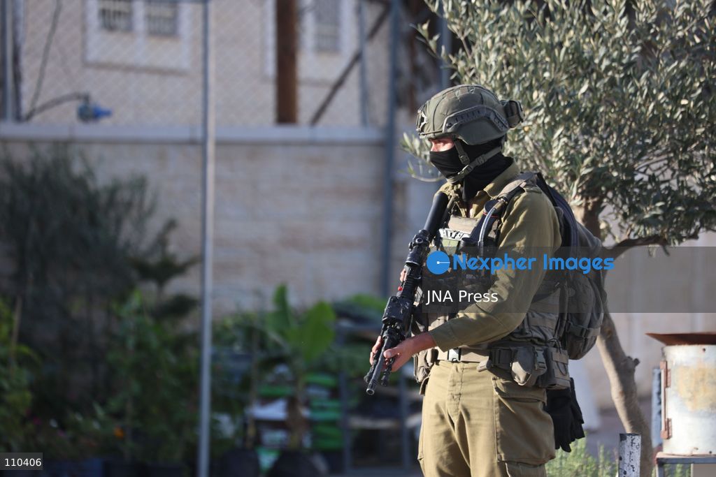 DURA, PALESTINE, OCTOBER 29, 2026: Israeli forces use a military bulldozer to demolish a memorial mural depicting Bajis Abu Atwan in the town of Dura, southwest of Hebron in the occupied West Bank. The demolition takes place during an Israeli military raid on the town. (Photo by Mosab shawer/JNA Press via Nexpher Images)