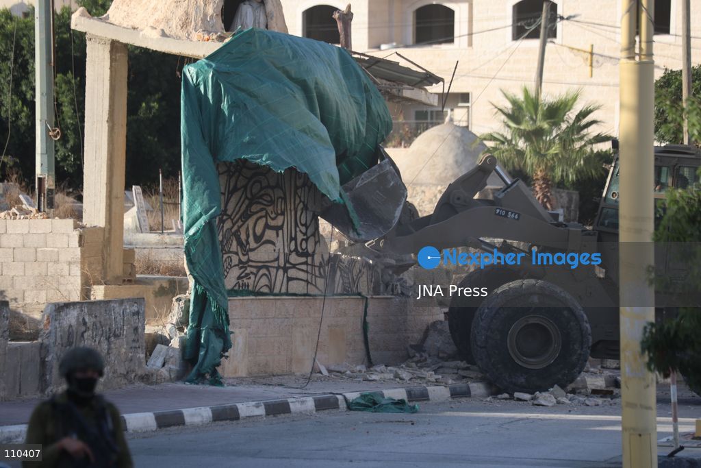 DURA, PALESTINE, OCTOBER 29, 2026: Israeli forces use a military bulldozer to demolish a memorial mural depicting Bajis Abu Atwan in the town of Dura, southwest of Hebron in the occupied West Bank. The demolition takes place during an Israeli military raid on the town. (Photo by Mosab shawer/JNA Press via Nexpher Images)
