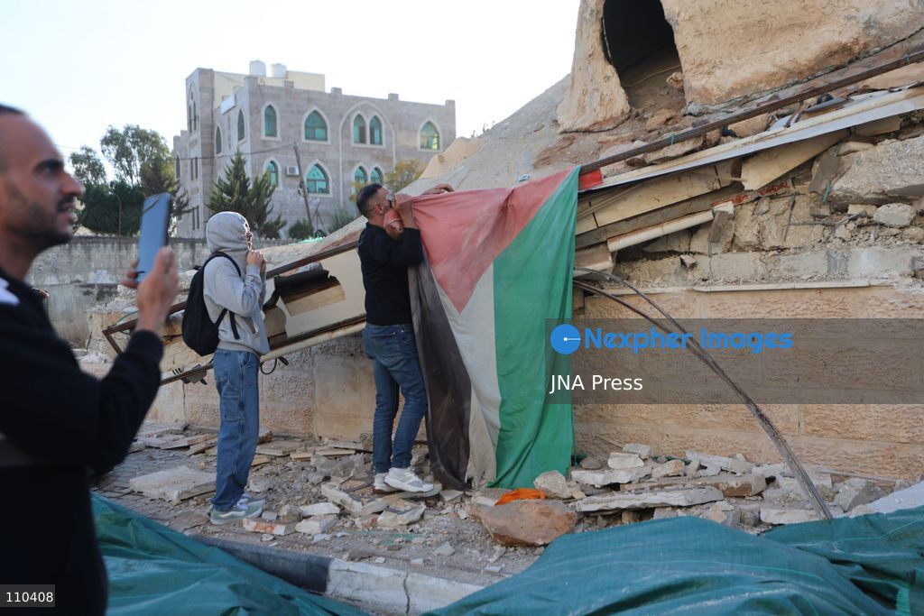 DURA, PALESTINE, OCTOBER 29, 2026: Israeli forces use a military bulldozer to demolish a memorial mural depicting Bajis Abu Atwan in the town of Dura, southwest of Hebron in the occupied West Bank. The demolition takes place during an Israeli military raid on the town. (Photo by Mosab shawer/JNA Press via Nexpher Images)