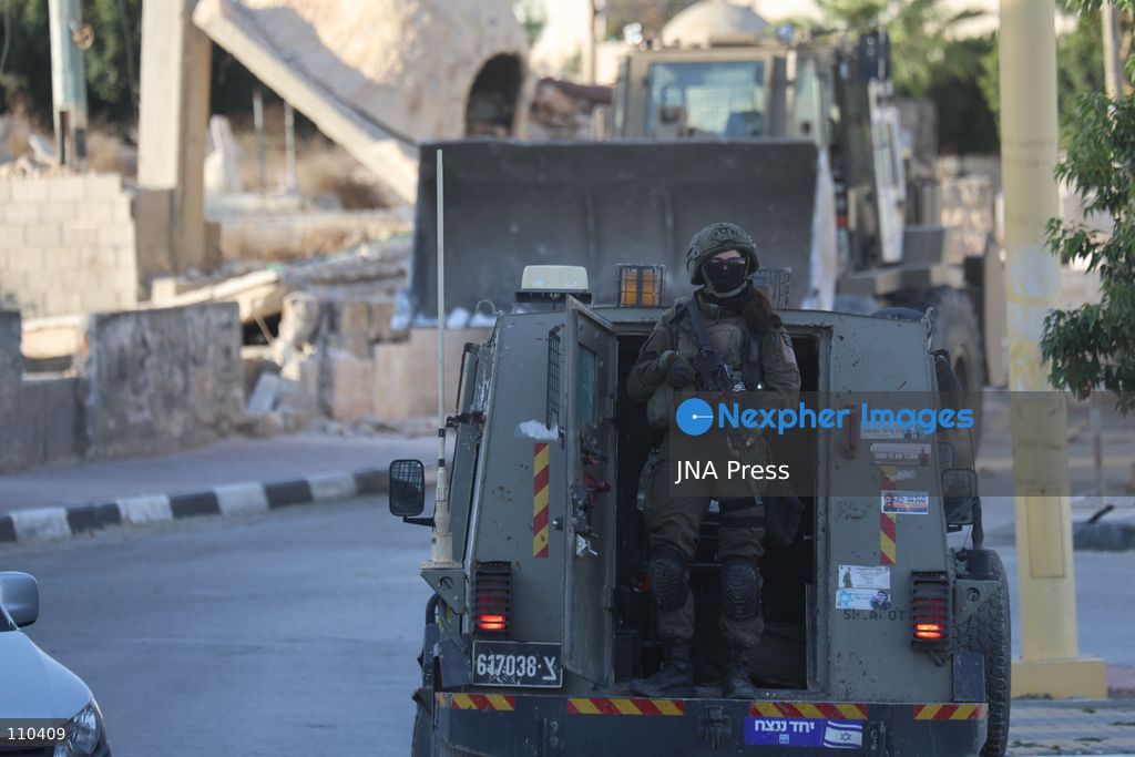 DURA, PALESTINE, OCTOBER 29, 2026: Israeli forces use a military bulldozer to demolish a memorial mural depicting Bajis Abu Atwan in the town of Dura, southwest of Hebron in the occupied West Bank. The demolition takes place during an Israeli military raid on the town. (Photo by Mosab shawer/JNA Press via Nexpher Images)