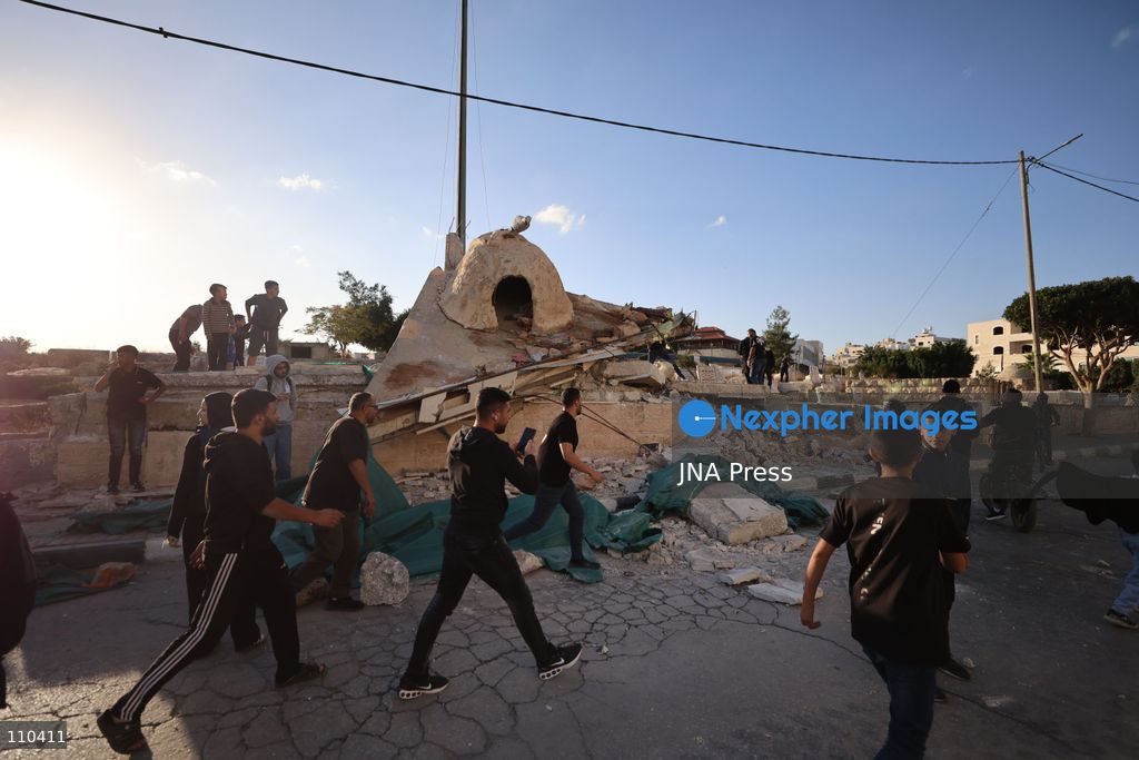 DURA, PALESTINE, OCTOBER 29, 2026: Israeli forces use a military bulldozer to demolish a memorial mural depicting Bajis Abu Atwan in the town of Dura, southwest of Hebron in the occupied West Bank. The demolition takes place during an Israeli military raid on the town. (Photo by Mosab shawer/JNA Press via Nexpher Images)
