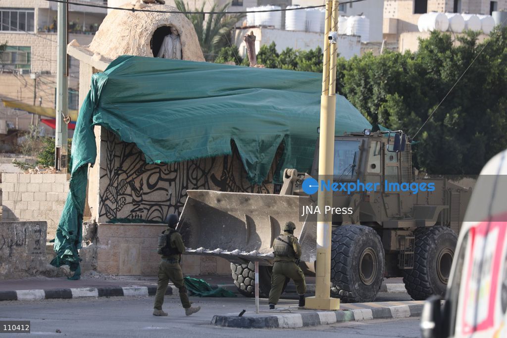 DURA, PALESTINE, OCTOBER 29, 2026: Israeli forces use a military bulldozer to demolish a memorial mural depicting Bajis Abu Atwan in the town of Dura, southwest of Hebron in the occupied West Bank. The demolition takes place during an Israeli military raid on the town. (Photo by Mosab shawer/JNA Press via Nexpher Images)