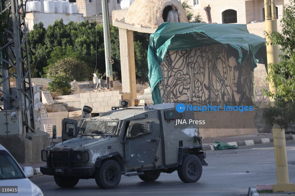 DURA, PALESTINE, OCTOBER 29, 2026: Israeli forces use a military bulldozer to demolish a memorial mural depicting Bajis Abu Atwan in the town of Dura, southwest of Hebron in the occupied West Bank. The demolition takes place during an Israeli military raid on the town. (Photo by Mosab shawer/JNA Press via Nexpher Images)