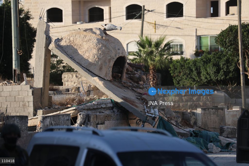 DURA, PALESTINE, OCTOBER 29, 2026: Israeli forces use a military bulldozer to demolish a memorial mural depicting Bajis Abu Atwan in the town of Dura, southwest of Hebron in the occupied West Bank. The demolition takes place during an Israeli military raid on the town. (Photo by Mosab shawer/JNA Press via Nexpher Images)
