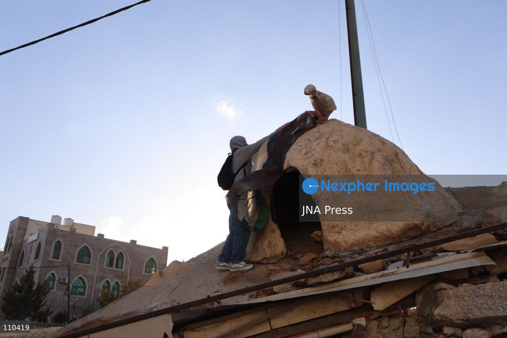 DURA, PALESTINE, OCTOBER 29, 2026: Israeli forces use a military bulldozer to demolish a memorial mural depicting Bajis Abu Atwan in the town of Dura, southwest of Hebron in the occupied West Bank. The demolition takes place during an Israeli military raid on the town. (Photo by Mosab shawer/JNA Press via Nexpher Images)