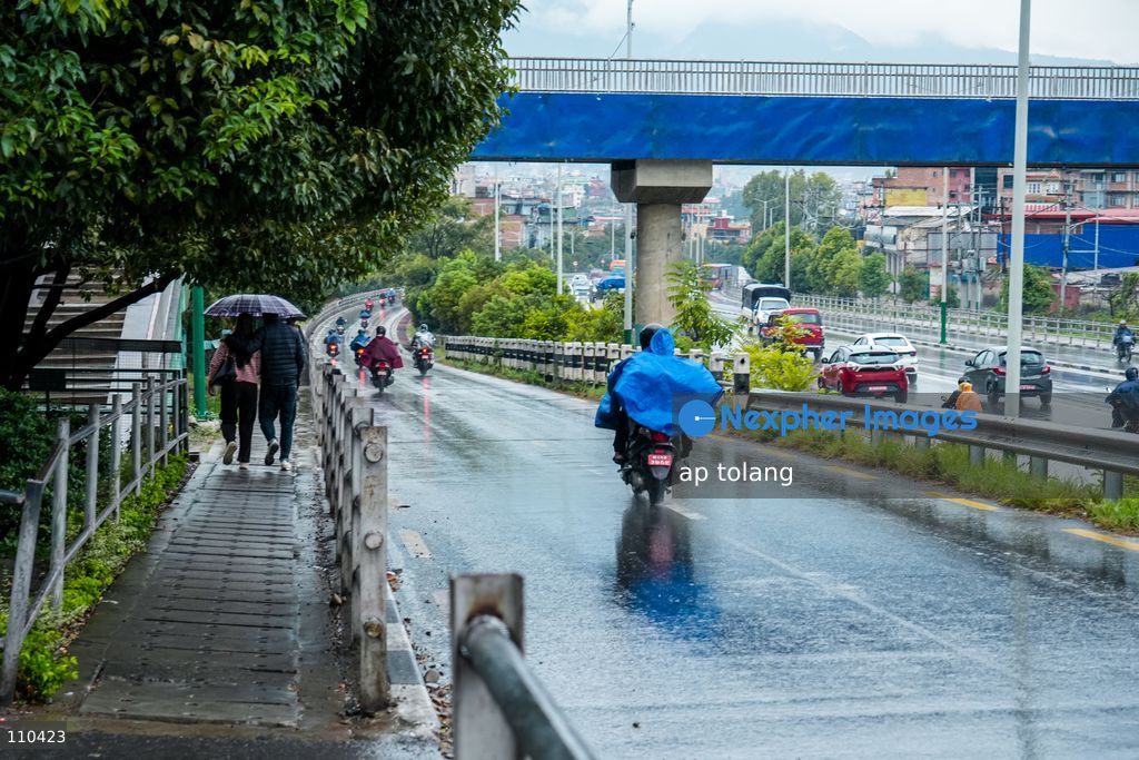Lalitpur, NEPAL – OCTOBER 30, 2026: Continuous rainfall caused by the remnants of Cyclone Arnab has disrupted daily life in Lalitpur, Nepal. People are seen wearing raincoats and carrying umbrellas as they go about their daily activities amid persistent rain since last night. (Photo by ap tolang/Nexpher Images)