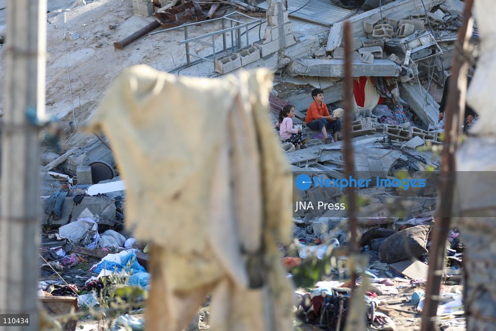 BUREIJ REFUGEE CAMP, PALESTINE, OCTOBER 30, 2026: Rubble covers the site of the al-Qarinawi family’s home following an Israeli airstrike in Bureij refugee camp in the central Gaza Strip. The strike on October 29 destroyed the residential building and caused extensive damage to surrounding homes. (Photo by Ramzi Abu Amer/JNA Press via Nexpher Images)
