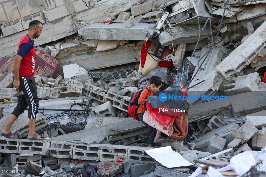 BUREIJ REFUGEE CAMP, PALESTINE, OCTOBER 30, 2026: Rubble covers the site of the al-Qarinawi family’s home following an Israeli airstrike in Bureij refugee camp in the central Gaza Strip. The strike on October 29 destroyed the residential building and caused extensive damage to surrounding homes. (Photo by Ramzi Abu Amer/JNA Press via Nexpher Images)