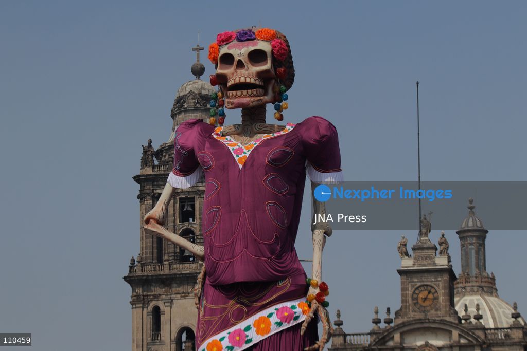 A monumental Catrina stands in Mexico City's Zócalo as the centerpiece of the 2026 Ofrenda Monumental. The roughly 32-meter figure, created by the Xibalbá art workshop, was unveiled as part of the Day of the Dead offering, which organizers said set a Guinness World Record for the tallest Catrina. The installation also features pieces from the exhibition "Ajolotes en el Corazón" and cempasúchil flowers. (Photo by Carlos Santiago/JNA Press via Nexpher Images)