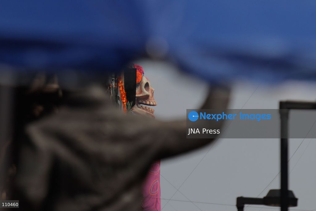 A monumental Catrina stands in Mexico City's Zócalo as the centerpiece of the 2026 Ofrenda Monumental. The roughly 32-meter figure, created by the Xibalbá art workshop, was unveiled as part of the Day of the Dead offering, which organizers said set a Guinness World Record for the tallest Catrina. The installation also features pieces from the exhibition "Ajolotes en el Corazón" and cempasúchil flowers. (Photo by Carlos Santiago/JNA Press via Nexpher Images)