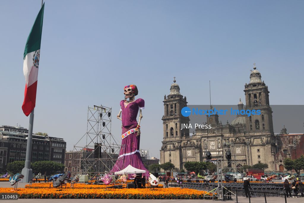 A monumental Catrina stands in Mexico City's Zócalo as the centerpiece of the 2026 Ofrenda Monumental. The roughly 32-meter figure, created by the Xibalbá art workshop, was unveiled as part of the Day of the Dead offering, which organizers said set a Guinness World Record for the tallest Catrina. The installation also features pieces from the exhibition "Ajolotes en el Corazón" and cempasúchil flowers. (Photo by Carlos Santiago/JNA Press via Nexpher Images)