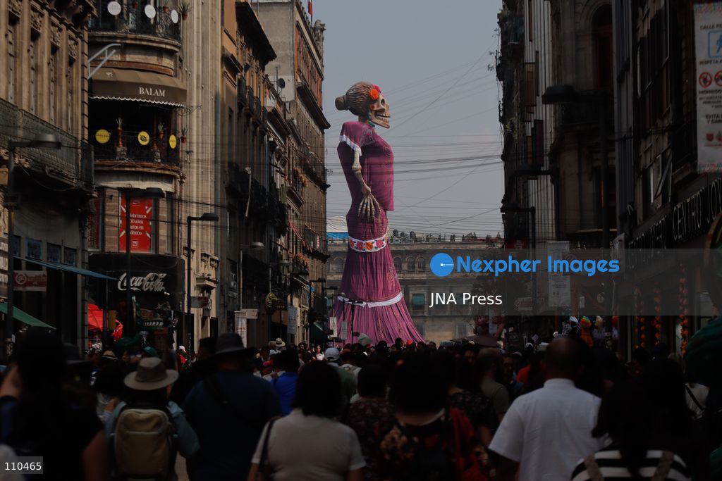 A monumental Catrina stands in Mexico City's Zócalo as the centerpiece of the 2026 Ofrenda Monumental. The roughly 32-meter figure, created by the Xibalbá art workshop, was unveiled as part of the Day of the Dead offering, which organizers said set a Guinness World Record for the tallest Catrina. The installation also features pieces from the exhibition "Ajolotes en el Corazón" and cempasúchil flowers. (Photo by Carlos Santiago/JNA Press via Nexpher Images)