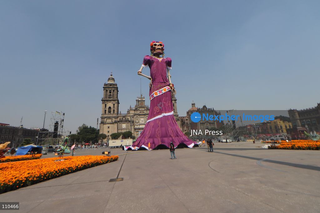 A monumental Catrina stands in Mexico City's Zócalo as the centerpiece of the 2026 Ofrenda Monumental. The roughly 32-meter figure, created by the Xibalbá art workshop, was unveiled as part of the Day of the Dead offering, which organizers said set a Guinness World Record for the tallest Catrina. The installation also features pieces from the exhibition "Ajolotes en el Corazón" and cempasúchil flowers. (Photo by Carlos Santiago/JNA Press via Nexpher Images)