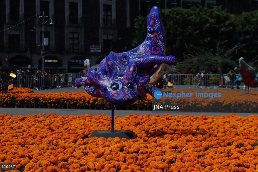 A monumental Catrina stands in Mexico City's Zócalo as the centerpiece of the 2026 Ofrenda Monumental. The roughly 32-meter figure, created by the Xibalbá art workshop, was unveiled as part of the Day of the Dead offering, which organizers said set a Guinness World Record for the tallest Catrina. The installation also features pieces from the exhibition "Ajolotes en el Corazón" and cempasúchil flowers. (Photo by Carlos Santiago/JNA Press via Nexpher Images)